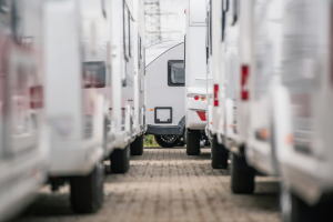 A double row of RVs on a dealership lot