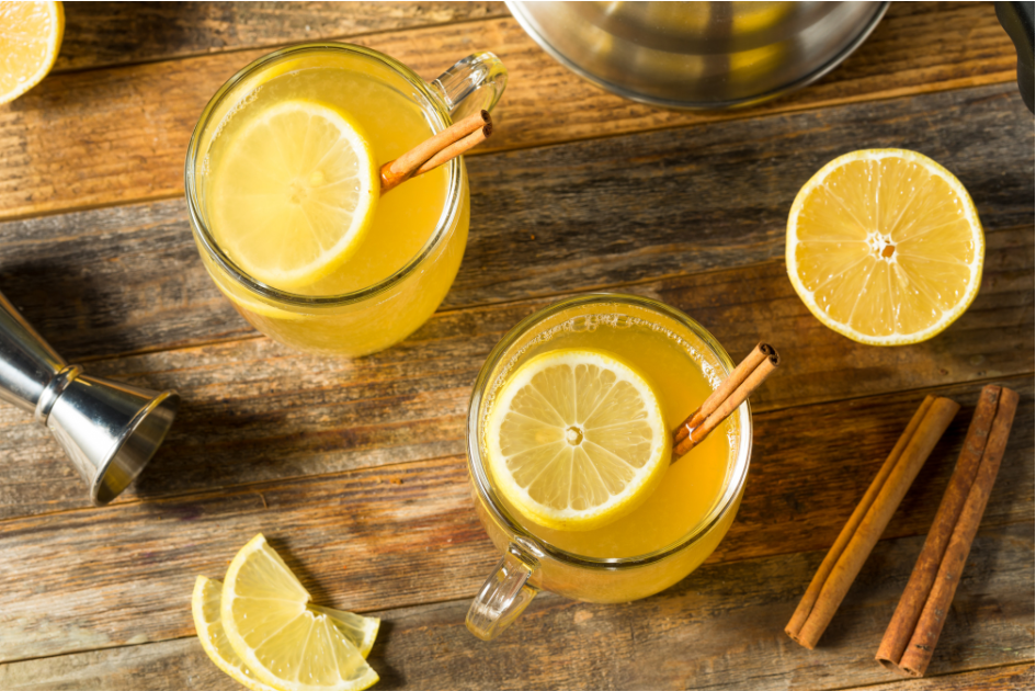 Warm hot toddies with cinnamon and lemon wedges. Perfect camping drink recipe.
