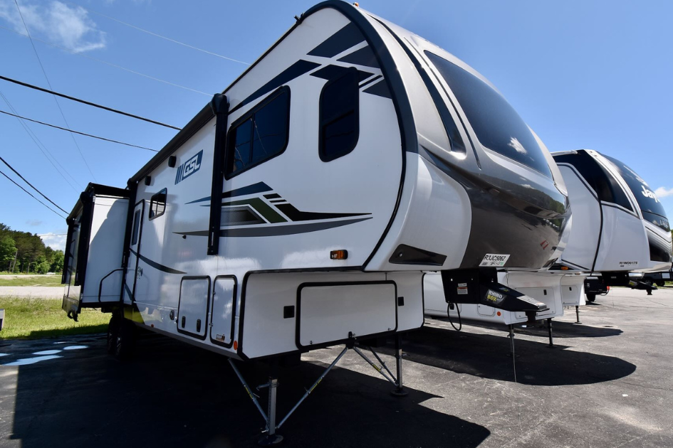 Two Fifth Wheel Travel Trailers parked next to each other in Christie's RV lot.