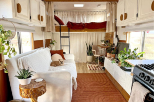 Dog laying on white couch inside a beautifully decorated RV