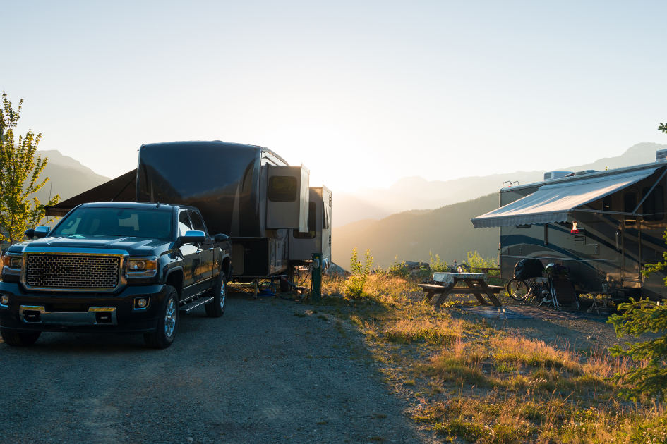Two fifth wheel travel trailers parked in an off-grid area